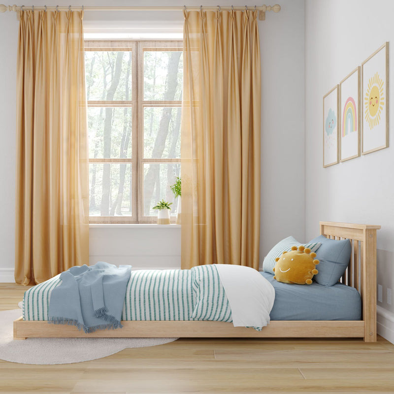 Scandinavian kids bedroom with natural wood low bed, blue striped bedding, yellow curtains, sun plush pillow, rainbow wall art and window plants