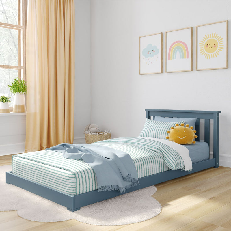 Bright modern children's bedroom with blue toddler bed, striped teal bedding, smiling sun plush, pastel rainbow and cloud nursery wall art, beige curtains and natural light