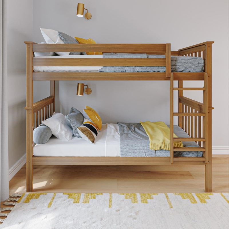 Modern wooden bunk bed with ladder in kids' bedroom, gray knit blankets and yellow accent pillows, brass wall sconces on neutral wall