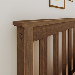 Wooden slatted headboard in walnut finish with beveled top rail, modern rustic bedroom furniture close-up