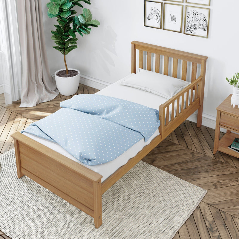 Single natural wood slatted bed frame with light blue polka-dot duvet and white pillow in a bright minimalist Scandinavian bedroom with potted plant, wooden nightstand and chevron wood floor