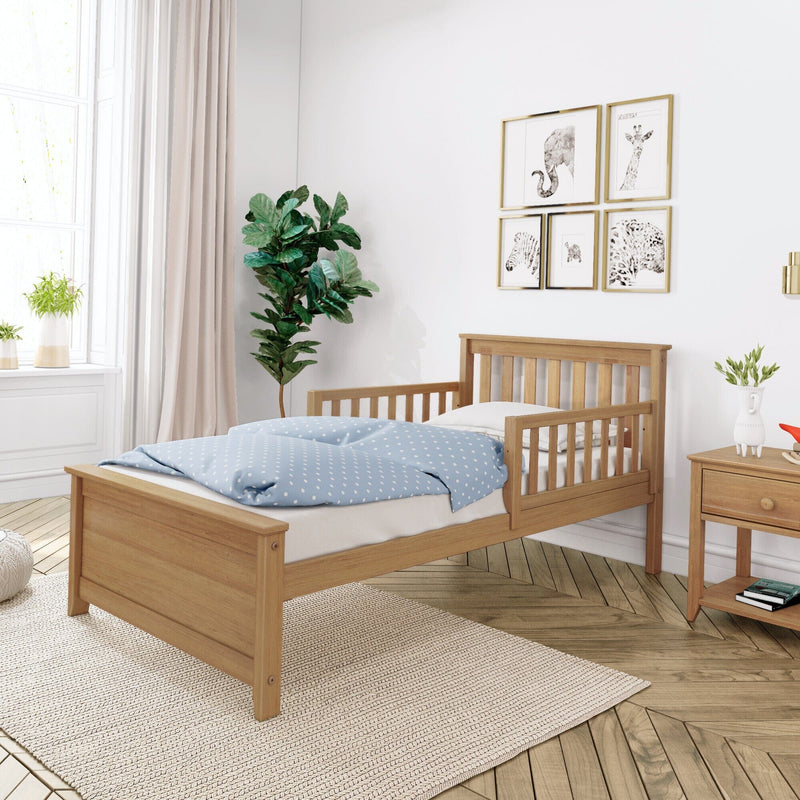 Scandinavian kids bedroom with natural wood toddler bed, blue polka-dot duvet, animal wall art and potted indoor plants