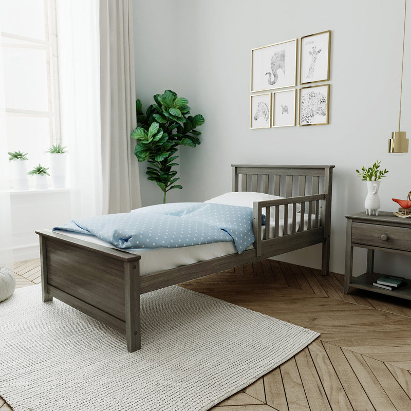 Gray wooden twin bed with blue bedding in kids bedroom with nightstand, animal art, fiddle-leaf plant and natural light