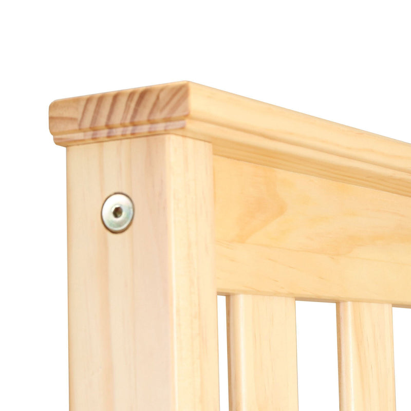 Pine wood bed frame corner with natural finish.