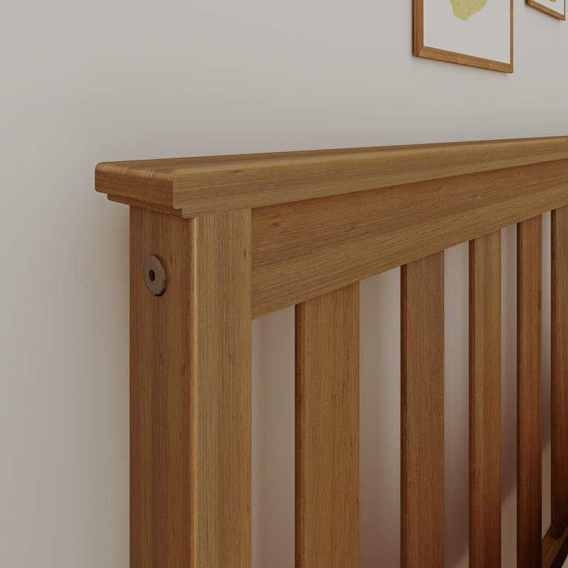 Close-up of solid oak slatted bed headboard showing natural wood grain and modern bedroom wall art