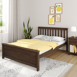 Modern bedroom with dark wood bed frame, yellow bedding, plant, and wall art.