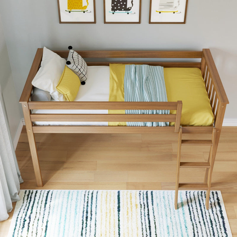 Children's wooden loft bed with ladder, yellow bedding, patterned pillows and blue striped throw in a modern nursery with framed wall art and striped area rug