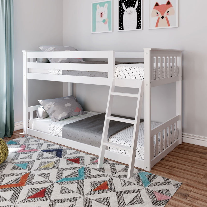 White wooden twin bunk bed with ladder in modern kids' bedroom, polka-dot bedding, animal wall art, colorful geometric rug