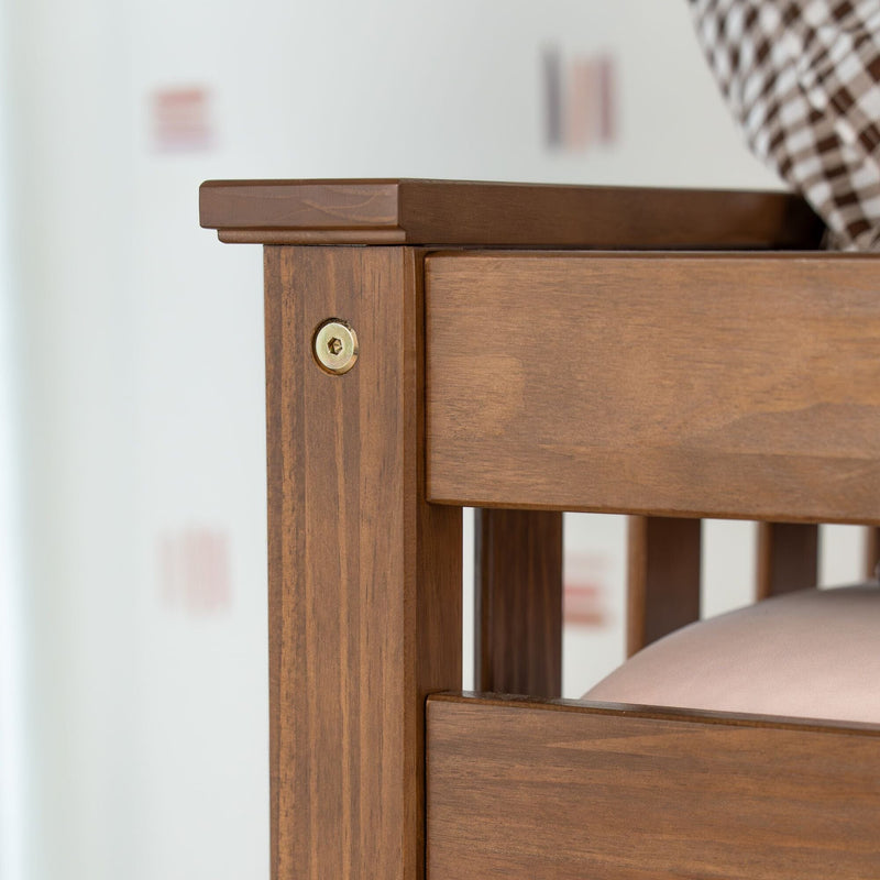 Close-up of brown wooden bed frame corner with oak finish, visible wood grain, brass screw and slatted headboard joinery