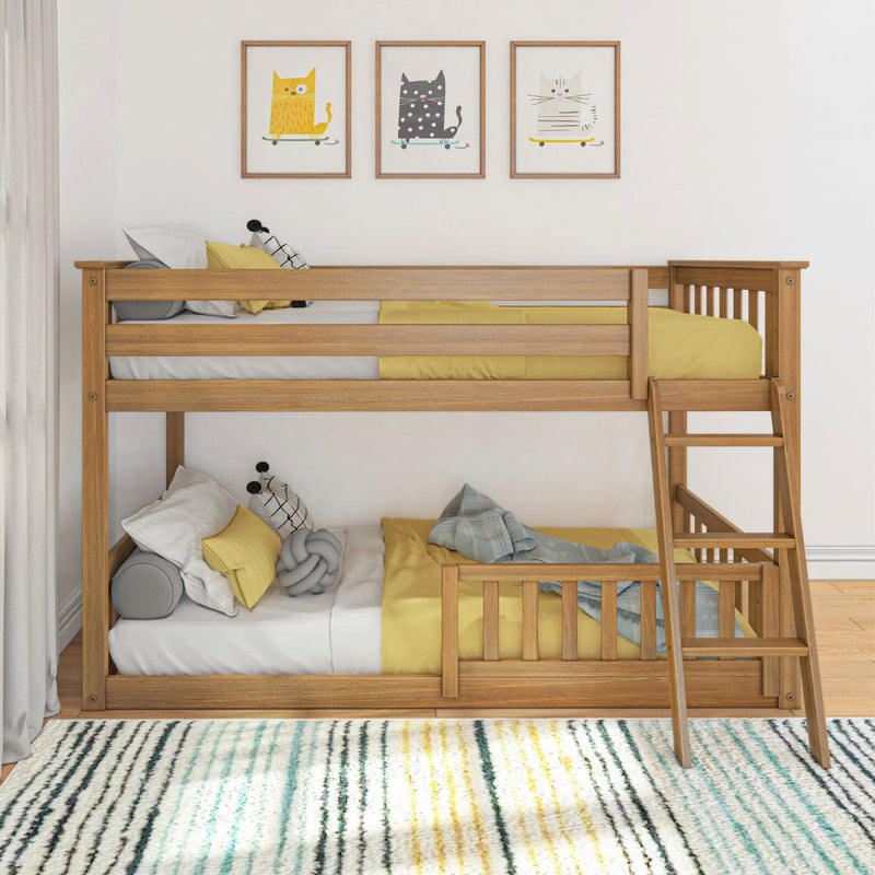 Space-saving wooden bunk bed with yellow bedding, decorative pillows, and three framed cat prints above in a modern children's bedroom
