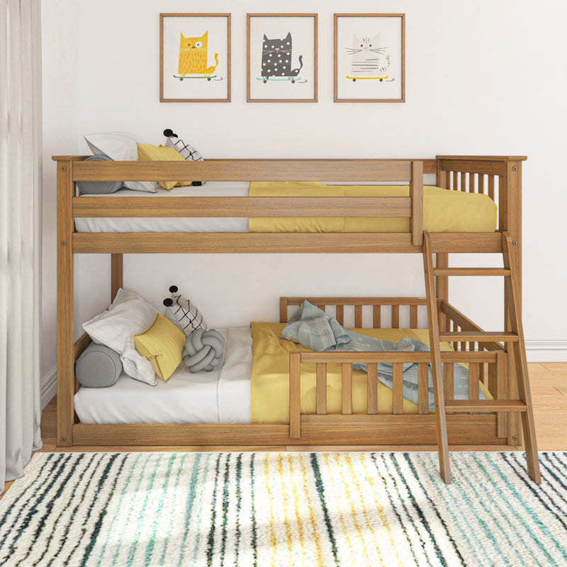 Wooden bunk bed with yellow bedding, cozy pillows and striped rug beneath whimsical cat framed prints in modern kids' bedroom nursery decor