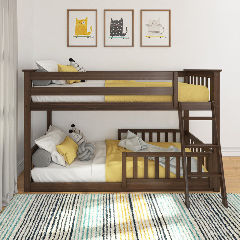 Wooden bunk bed with yellow bedding, ladder and cushions under framed playful cat wall art in a bright modern kids' bedroom with striped rug