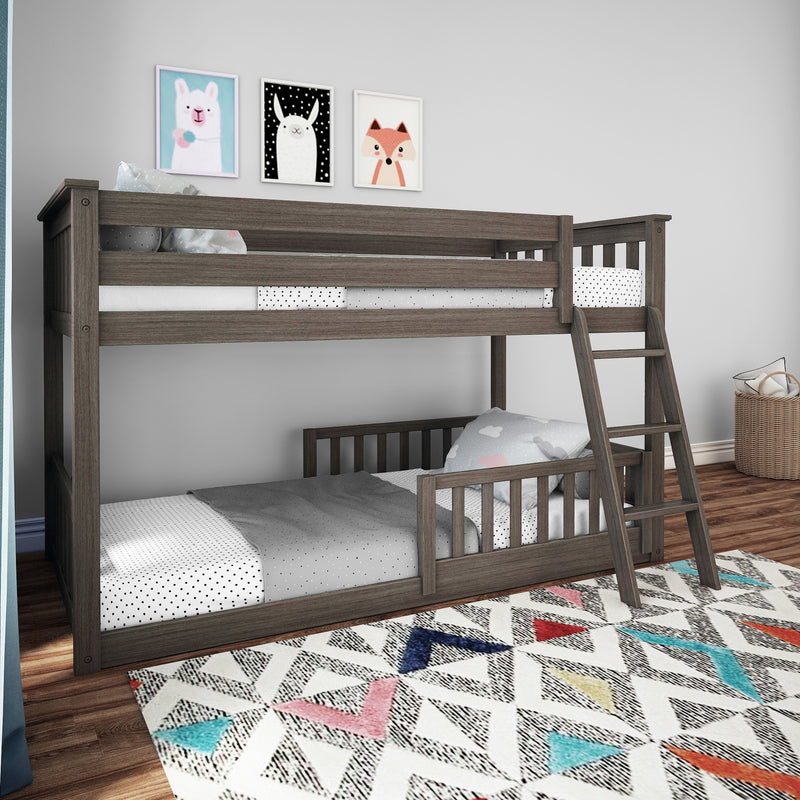 Gray wooden twin-over-twin bunk bed with ladder in children's bedroom, polka-dot bedding, animal wall prints and colorful geometric rug