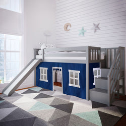 Children's loft bed with slide and stairs in a cozy bedroom, featuring blue playhouse curtains and geometric patterned rug.