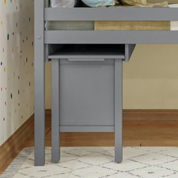 Gray storage furniture under loft bed with polka dot wall decor and geometric rug.