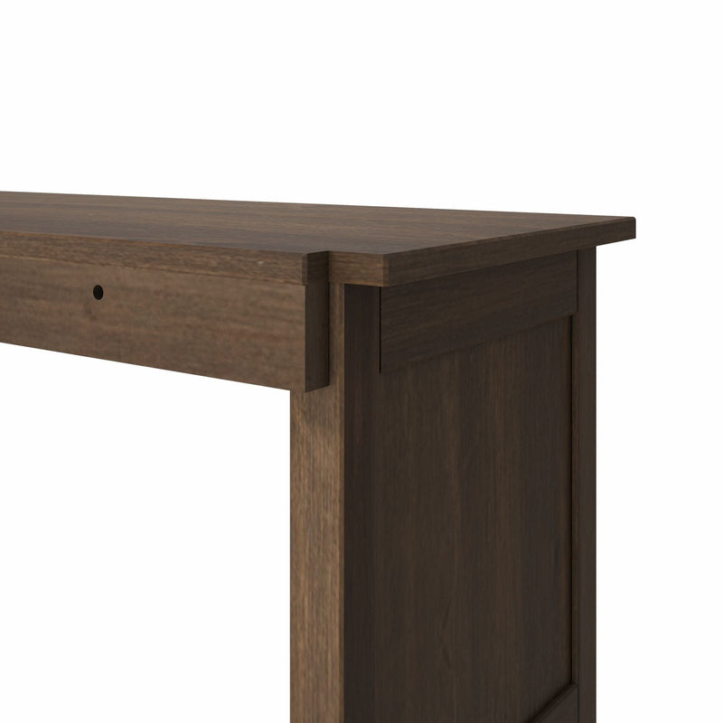 Close-up of dark brown wooden console table top with beveled edge and drawer-front detail on white background