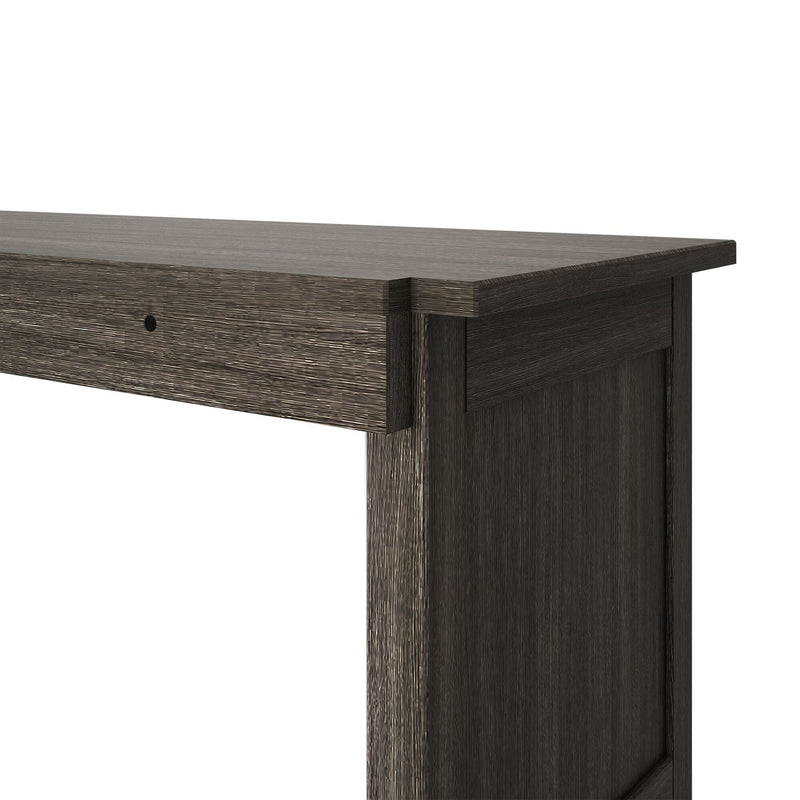 Close-up of dark brown textured wood dresser corner showing top surface, drawer front and wood grain, modern rustic furniture