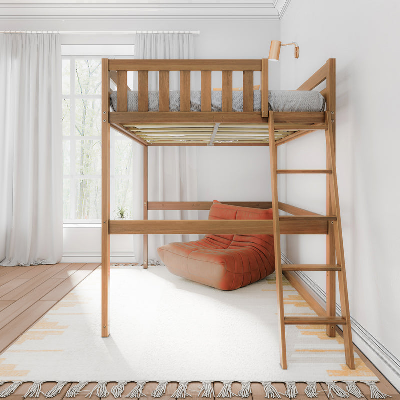 Wooden loft bed with ladder above orange lounge chair in bright modern bedroom with white curtains and large window