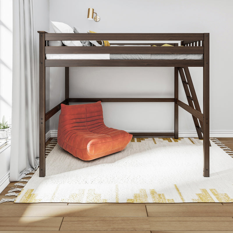 Dark walnut loft bed with ladder above a cozy reading nook, orange lounge chair and white patterned rug in a minimalist bedroom