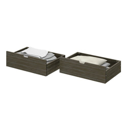 Set of two dark wood storage drawers filled with neatly folded clothes and bedding.