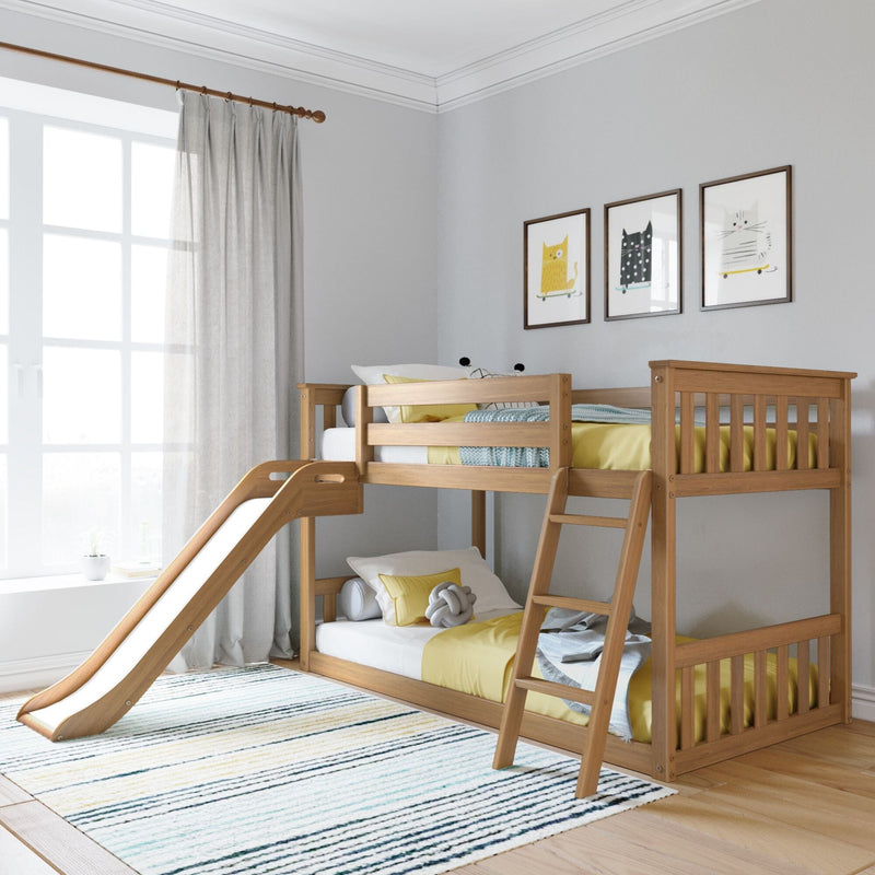 Wooden kids bunk bed with slide and yellow bedding in a bright modern children's bedroom with cat wall art, sheer curtains, and natural light