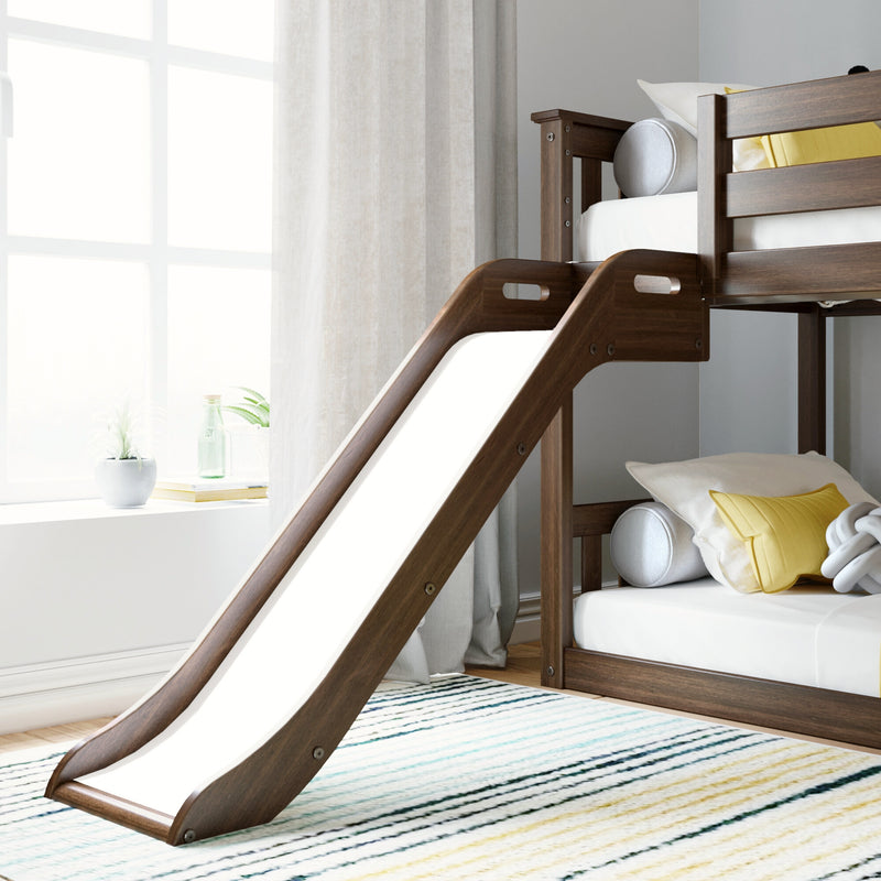 Dark wood kids bunk bed with built-in slide, white bedding and yellow accent pillow in a bright modern kids' bedroom by a sunlit window