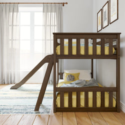 Wooden bunk bed with built-in slide in a bright, airy children's bedroom featuring yellow bedding and decorative wall art.