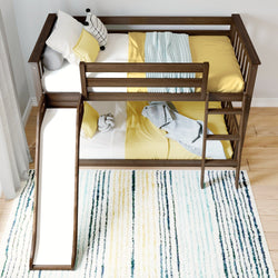 Wooden bunk bed with slide, yellow bedding, and decorative pillows, perfect for a children's bedroom.