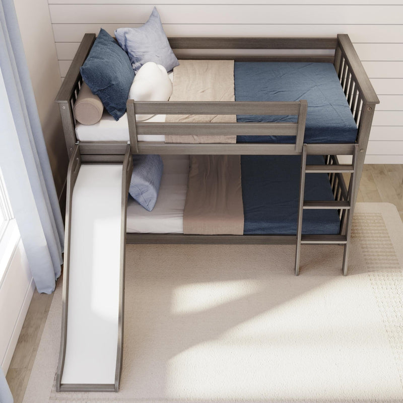 Gray wooden loft bunk bed with built-in slide and ladder, blue and beige bedding and accent pillows in a modern kids' bedroom