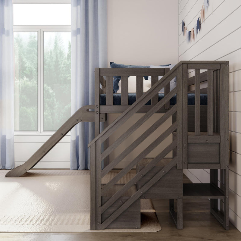 Wooden kids loft bed with slide and stairs in modern neutral children's bedroom with blue curtains and pennant garland by large window