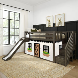 Kids loft bed with slide and cottage theme, featuring dark wooden stairs, decorative curtains, and bunny artwork in a bright bedroom.