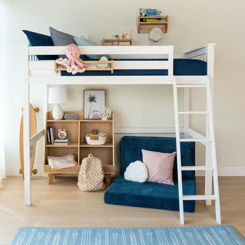 Children's white loft bed with ladder and navy bedding, pink plush octopus, wooden storage cubbies, skateboard and backpack in a modern kids' bedroom