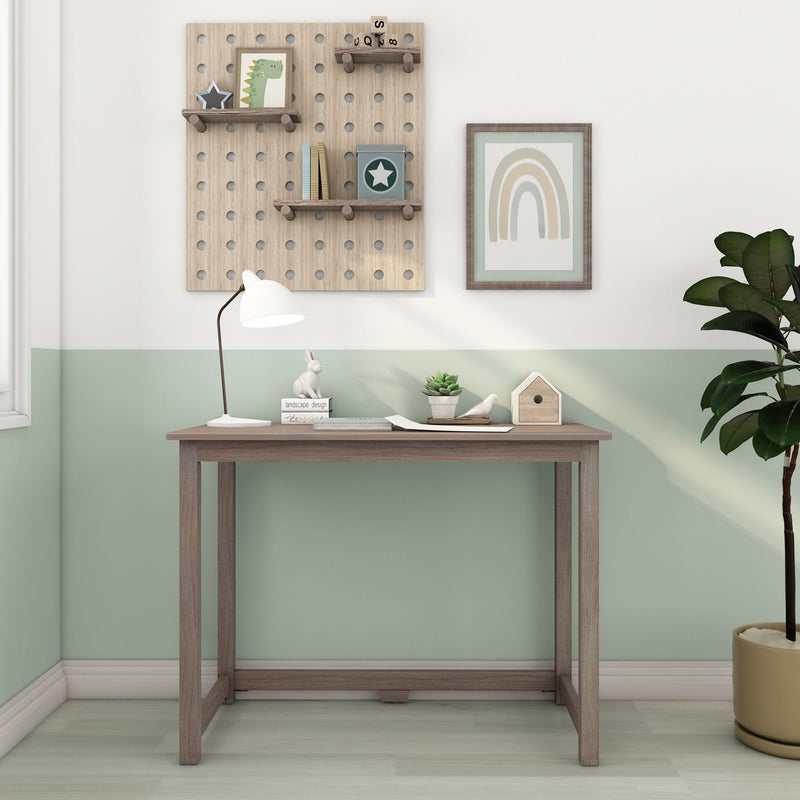 Scandinavian nursery workspace with wooden pegboard shelves, framed rainbow print, white desk lamp, succulent and birdhouse on a wooden console table against a mint green accent wall