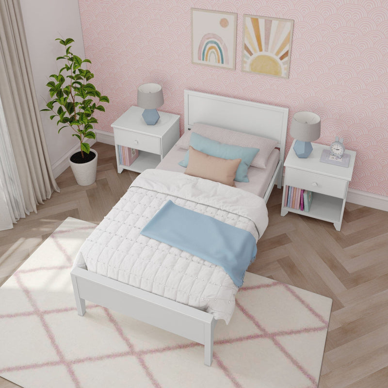 Pastel girls' bedroom with white twin bed, pink patterned wallpaper, pastel pillows and blue throw, white nightstands with geometric blue lamps, potted plant and rainbow wall art