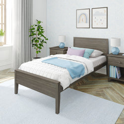 Contemporary bedroom with a single wooden bed, blue and white bedding, modern decor, and natural light.