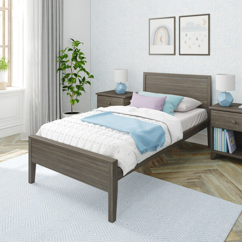 Modern cozy bedroom with gray wood bed frame, pastel blue and lavender bedding, matching nightstands, blue lamps, framed wall art and potted plant