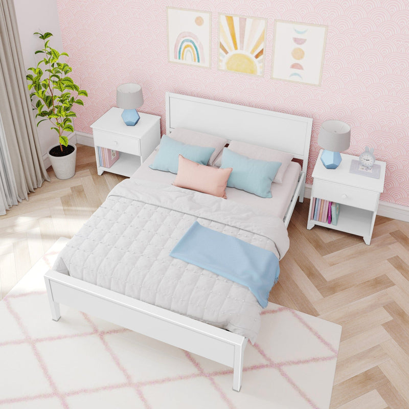 Pastel pink bedroom with white bed and quilt, pastel blue and pink throw pillows, white nightstands with blue geometric lamps, framed rainbow and sun wall art, potted plant, pink scallop-pattern wallpaper and chevron hardwood floor