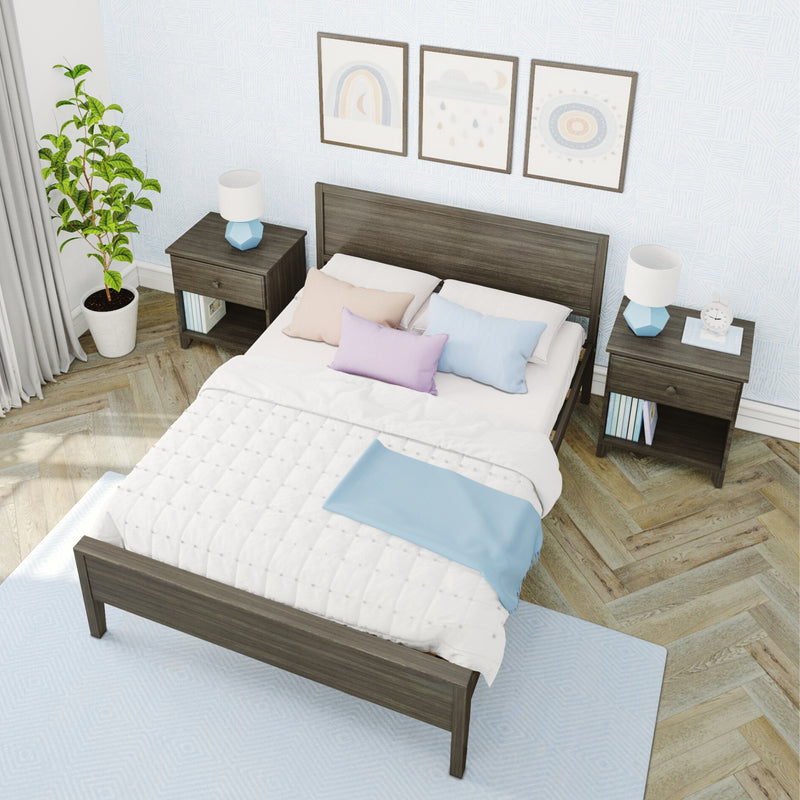Cozy modern bedroom decor with dark wood bed frame, quilted white duvet, pastel pillows, matching nightstands with blue geometric lamps, potted plant, framed wall art, light blue patterned wallpaper, herringbone hardwood floor