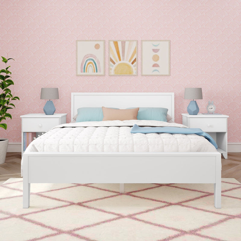 Modern bedroom with white bed frame, pink geometric wallpaper, colorful art, and blue accents.