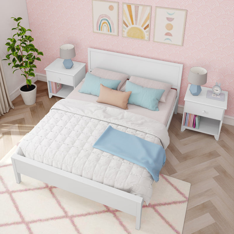 Stylish pastel pink kids' bedroom with white bed and nightstands, blue and peach throw pillows, patterned pink wallpaper, rainbow and sun wall art, geometric bedside lamps, potted plant, and light wood herringbone flooring