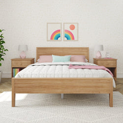 Minimalist bedroom with wooden bed frame, colorful throw pillows, and modern decor accents.