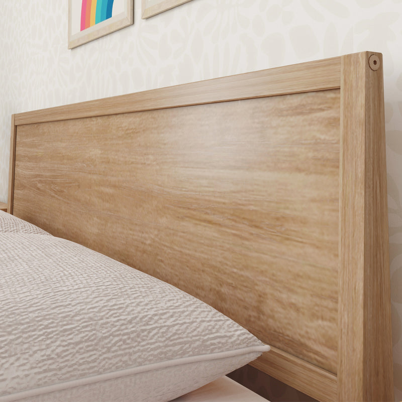 Light oak wooden headboard with neutral quilted bedding and subtle textured wallpaper in a modern minimalist bedroom interior