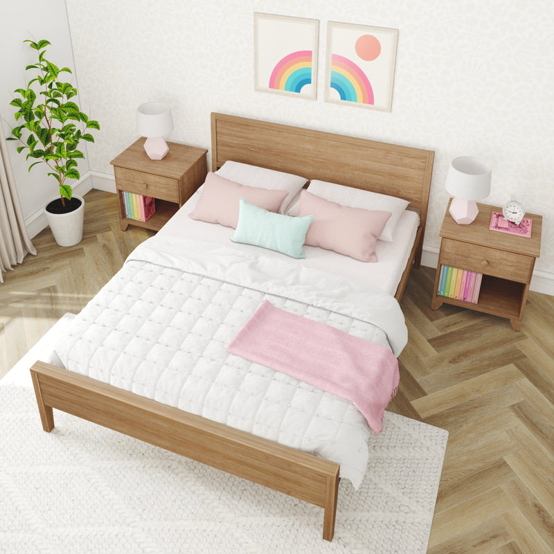 Cozy minimalist bedroom with wooden bed frame, white quilt and pastel pink pillows, matching wooden nightstands with geometric lamps, potted plant and rainbow wall art