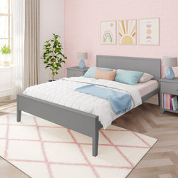 Modern bedroom with gray bed frame, pastel bedding, and decorative wall art in a bright, stylish interior design.