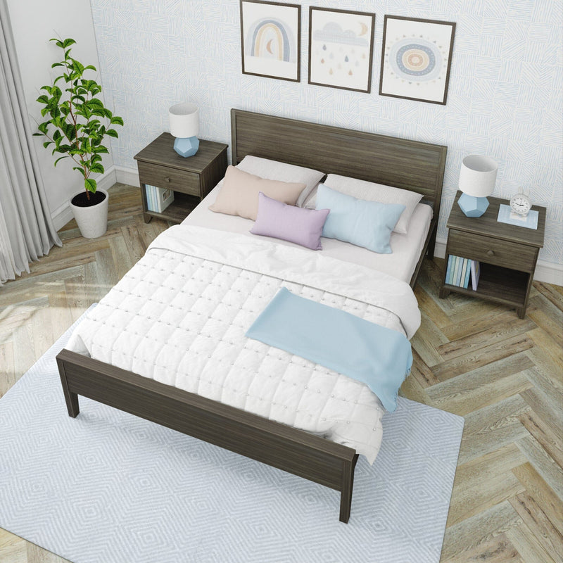 Modern minimalist bedroom with dark wood bed, matching nightstands, white quilt, pastel pillows, blue lamps, framed art, potted plant