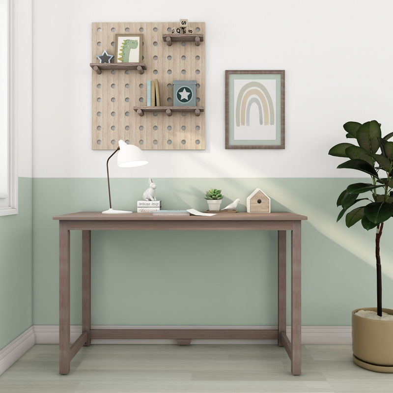 Minimalist children's room workspace with wooden pegboard shelves holding dinosaur print, star box and books, framed rainbow art, white desk lamp, succulent and birdhouse on a wooden console against a mint green wall