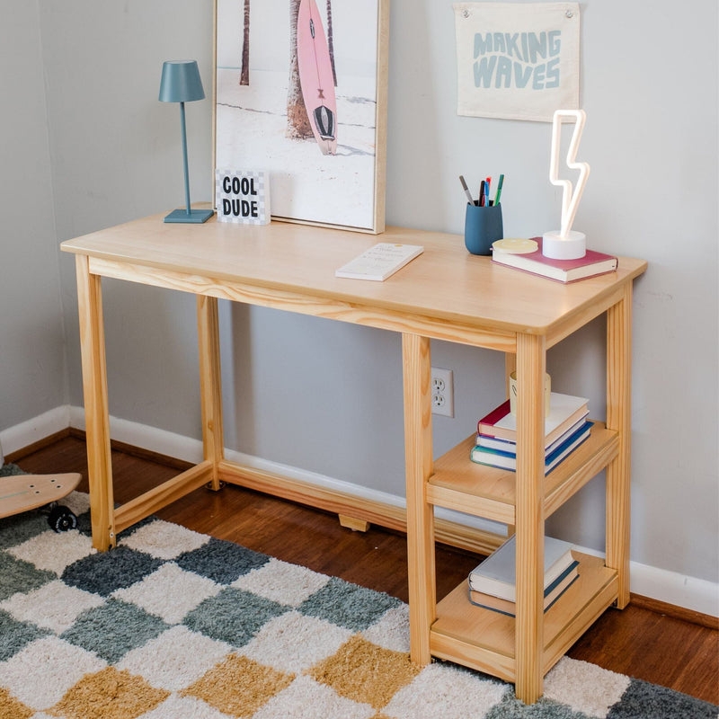 Minimalist wooden desk with lamp, books, and decor in a modern home office setting.
