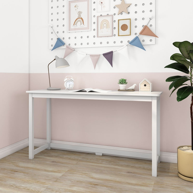 White minimalist writing desk in pastel pink children's room with desk lamp, bunting, succulent and potted plant — modern small-space study table