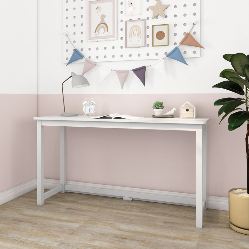 White children's desk styled with pastel bunting, pegboard gallery art, lamp, alarm clock and succulent in a pink Scandinavian nursery room