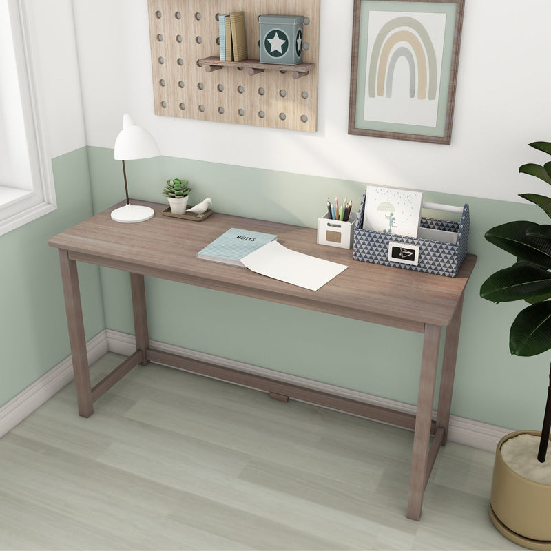 Minimalist kids desk workspace with light wood study desk, white desk lamp, succulent plant, pencil organizer, pegboard shelf and framed rainbow art on a mint green wall